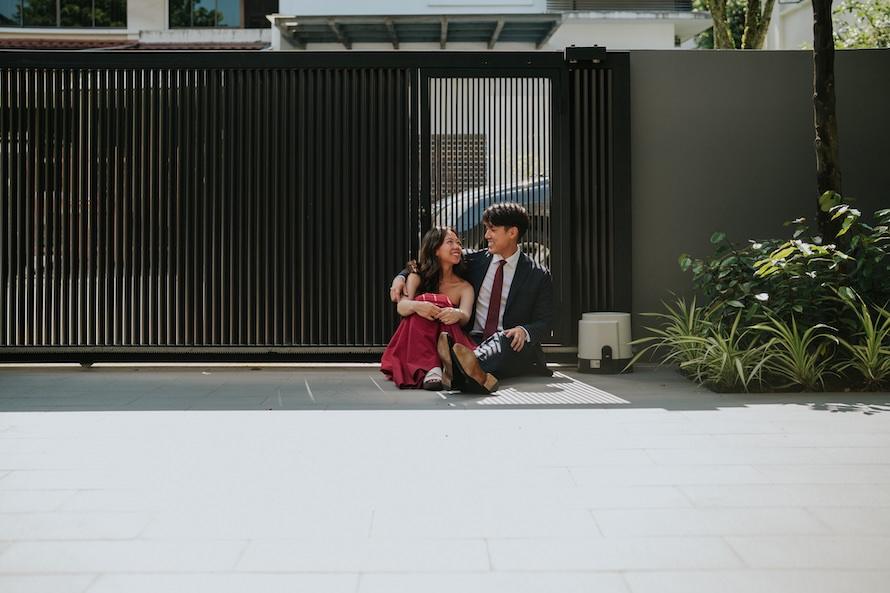 at home pre wedding couple seated infront of gate
