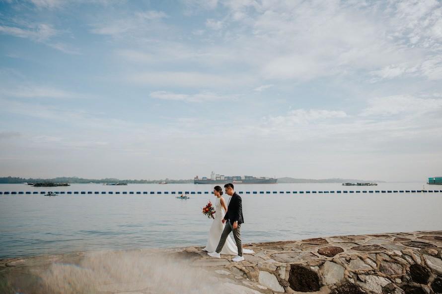 couple walking on break water beach singapore pre wedding